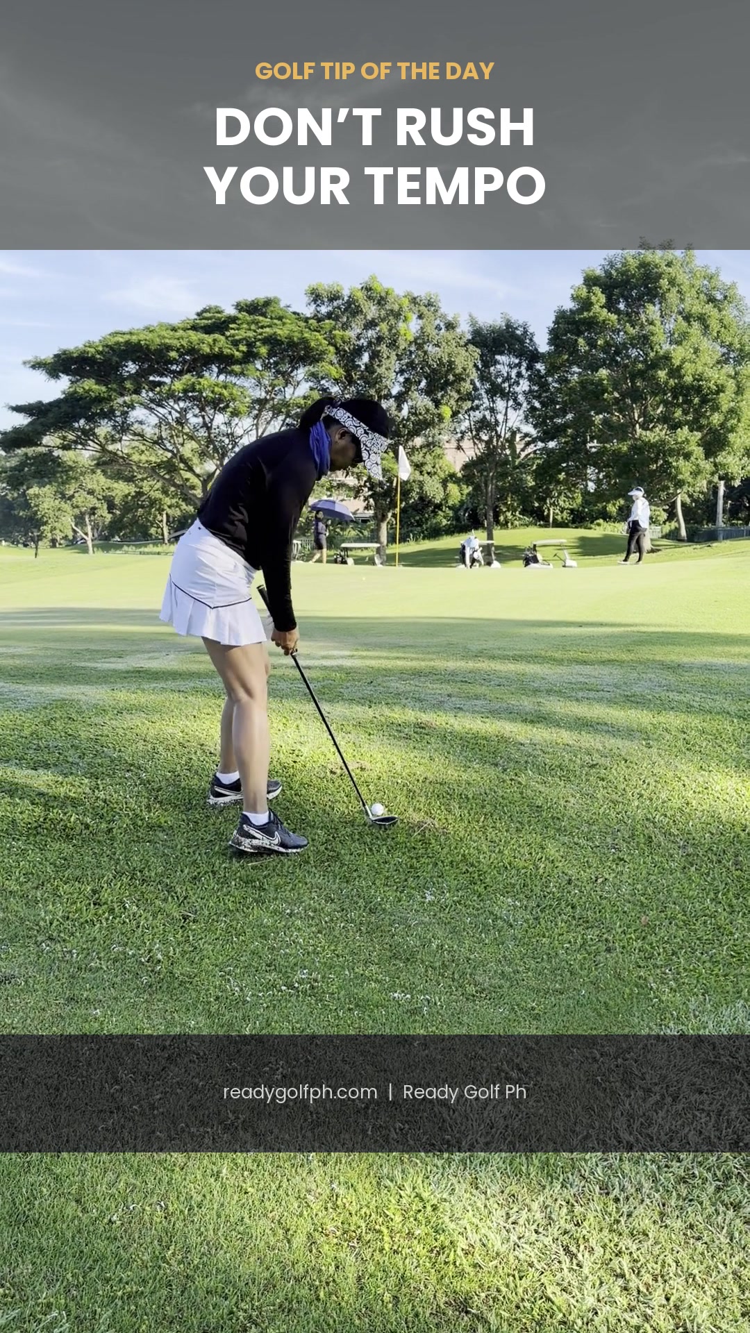 Golfer pausing deliberately at address before a smooth, unhurried chip swing near the green
