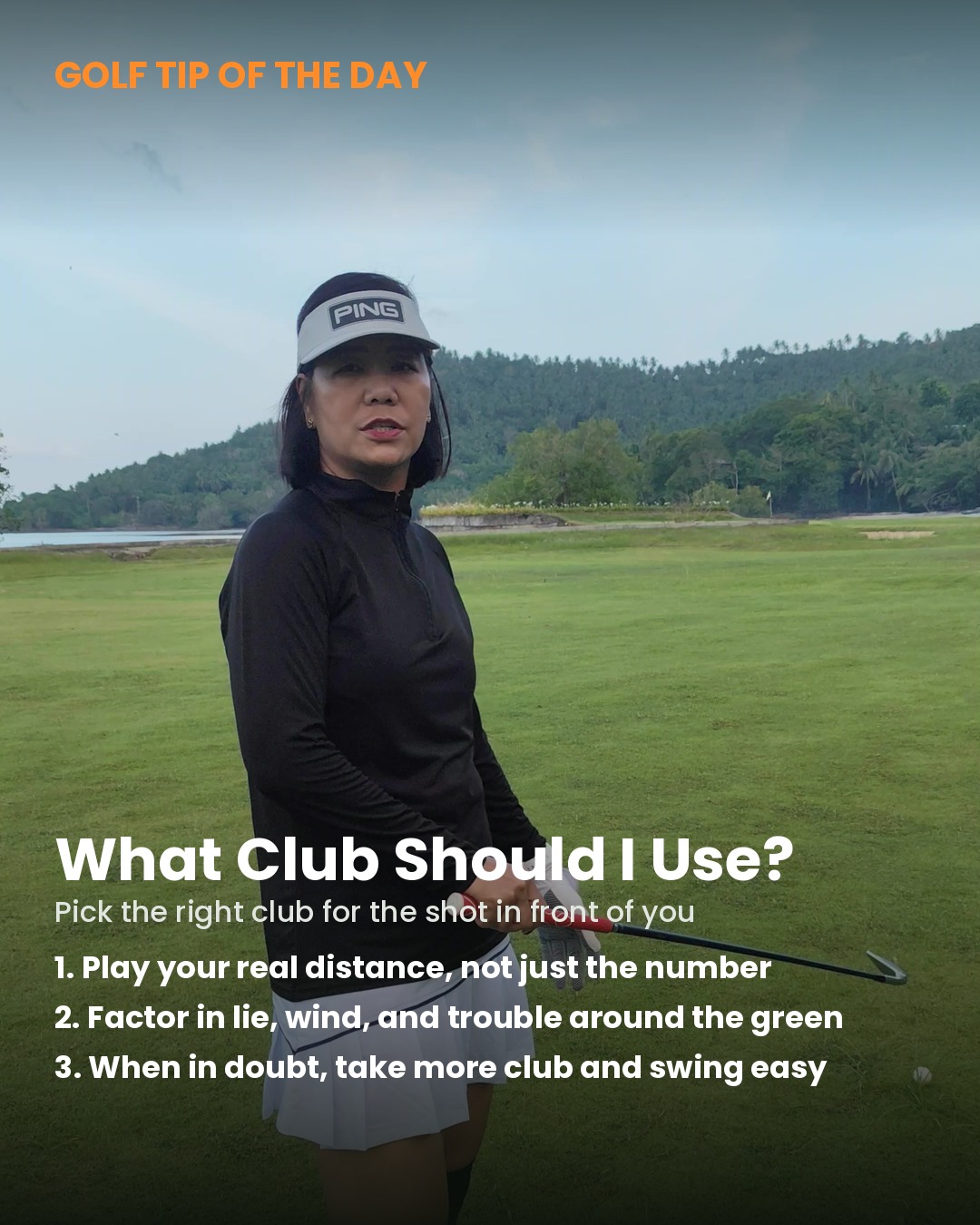 Golfer standing in the fairway with an iron in hand, assessing her approach shot before choosing a club